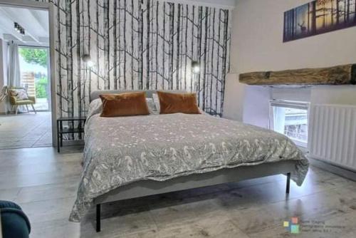 a bedroom with a large bed and a fireplace at Lî Gurni in Houffalize