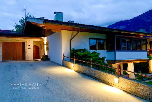 a house with lights on the side of it at Gartenwohnung an der Familienabfahrt in Brixen im Thale