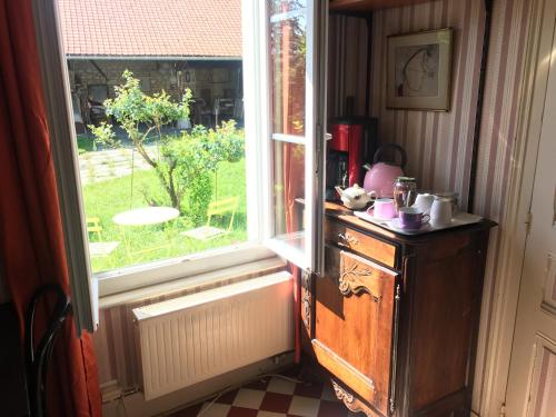 a kitchen with a window and a counter with a table at Le Refuge private entrance 2/4 pers dans maison 17eme siècle.Parking. calme in Autrêches