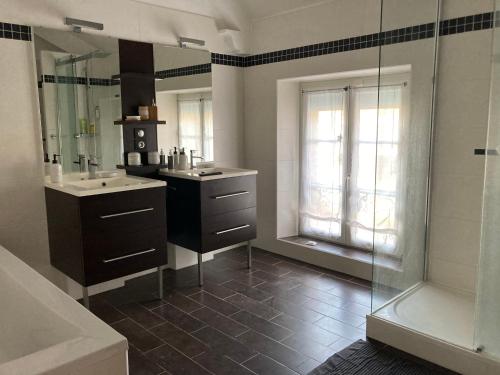 a bathroom with a shower and a sink and a tub at Le Clos Adnet in Villers-Marmery