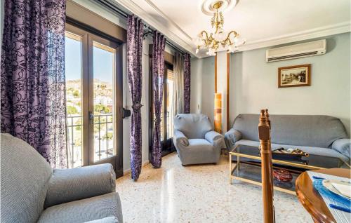 a living room with a couch and chairs and a window at 3 Bedroom Cozy Apartment In Pegalajar in Pegalajar