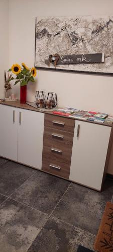 a counter with glasses and a vase of flowers on it at M4 Appartements in Wagrain