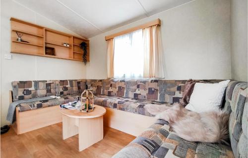 a living room with a couch and a table at 2 Bedroom Lovely Home In Heinkenszand in Heinkensand