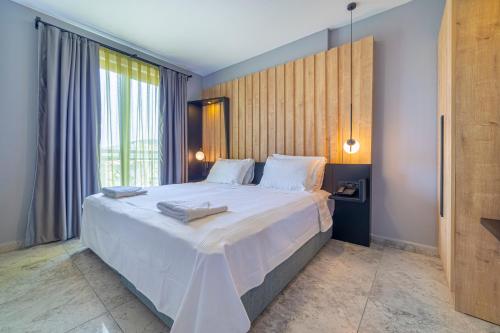 a bedroom with a large white bed with a large window at Aria Riva Apart Hotel in Alanya
