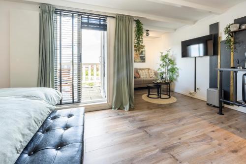 a bedroom with a bed and a large window at Zandvoort-17 in Zandvoort