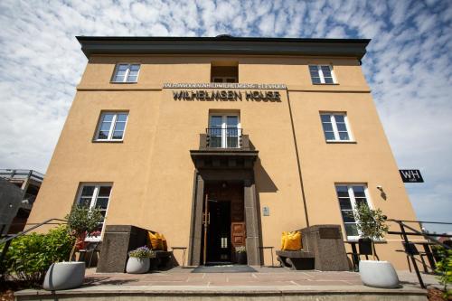 a building with a sign on the front of it at Wilhelmsen House in Tønsberg