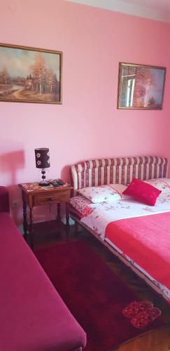 a bedroom with a bed and a table with a laptop at Guest House Cinderella in Herceg-Novi