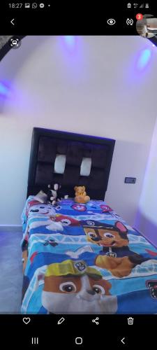 a bedroom with a large bed with a disney blanket at Saidia maroc in Saïdia