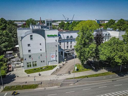an aerial view of a building in a city at Holiday Inn Lübeck by IHG in Lübeck