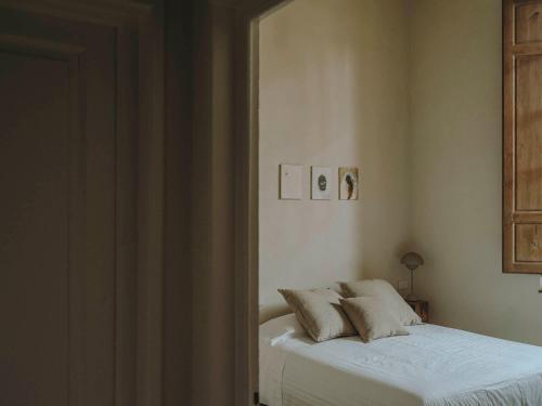 a bedroom with a bed with two pillows on it at Numeroventi Design Residency in Florence