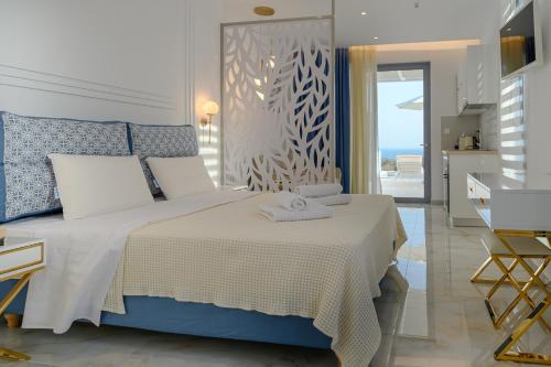 a bedroom with a bed and a view of the ocean at Dionisos Suites in Lixouri