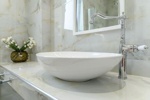 a white sink on a counter in a bathroom at Dionisos Suites in Lixouri