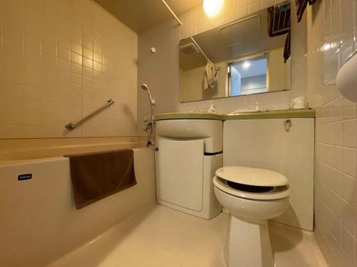 a bathroom with a toilet and a sink and a tub at Hotel Ginsui - Vacation STAY 58210v in Kanayama