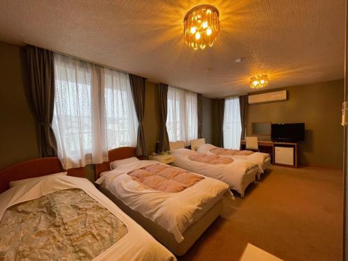 a hotel room with three beds in a room at Hotel Ginsui - Vacation STAY 58210v in Kanayama