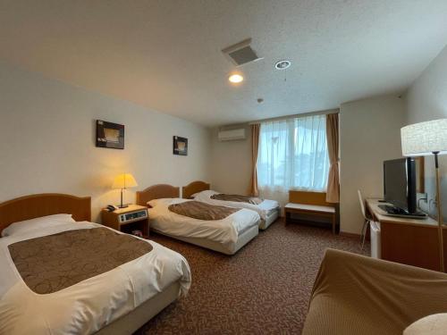 a hotel room with two beds and a television at Hotel Ginsui - Vacation STAY 58206v in Kanayama