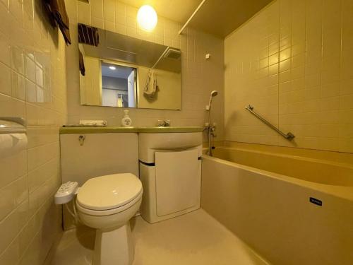 a bathroom with a toilet and a sink and a tub at Hotel Ginsui - Vacation STAY 58202v in Kanayama