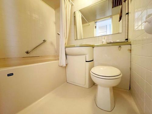 a bathroom with a toilet and a sink and a mirror at Hotel Ginsui - Vacation STAY 58198v in Kanayama