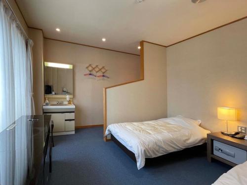 Marina Hotel Kaikuu - Vacation STAY 58563v في Kanayama: غرفه فندقيه بسرير ومطبخ