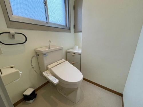 a bathroom with a white toilet and a window at Marina Hotel Kaikuu - Vacation STAY 58554v in Kanayama
