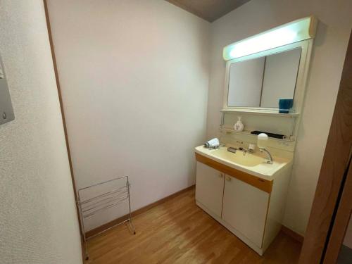 een badkamer met een wastafel en een spiegel bij Marina Hotel Kaikuu - Vacation STAY 58549v in Kanayama
