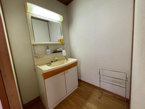 a bathroom with a sink and a mirror at Marina Hotel Kaikuu - Vacation STAY 58548v in Kanayama