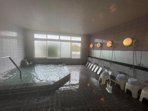 a bathroom with a tub with water in it at Marina Hotel Kaikuu - Vacation STAY 58502v in Kanayama