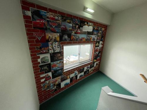a room with a brick wall with pictures on the wall at Marina Hotel Kaikuu - Vacation STAY 58502v in Kanayama