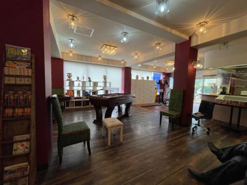 a room with a pool table and chairs in it at Marina Hotel Kaikuu - Vacation STAY 58502v in Kanayama