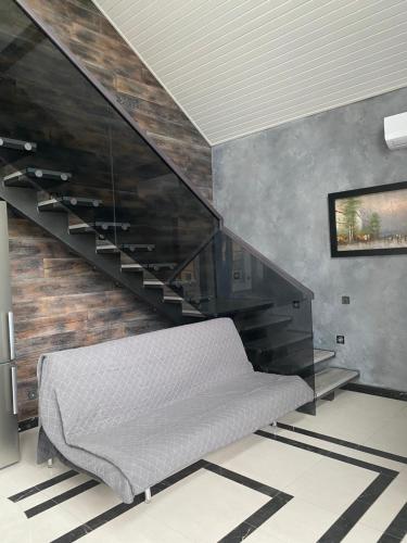 a room with a bed and a stair case at SEALEO in Gribovka