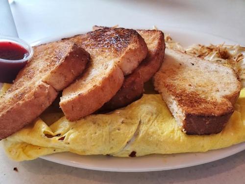 a plate with an omelet with bread and toast at Innlet Motel in Sturgeon Bay