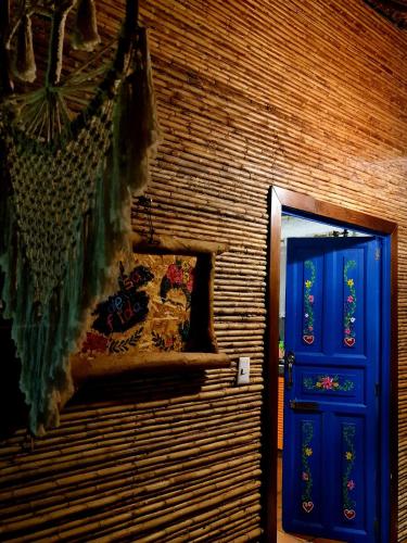 a room with a blue door and a brick wall at Cabañas Mannan in Tanchachín
