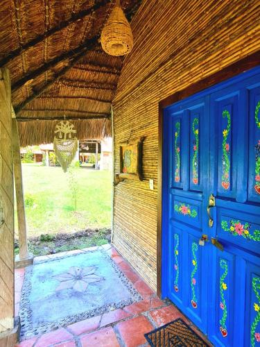 an entrance to a house with a blue door at Cabañas Mannan in Tanchachín