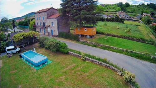 an aerial view of a house with a pool in the yard at ROULOTTE DE CHARME in Saint-Genest-de-Bauzon