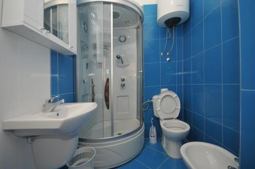 y baño con ducha, aseo y lavamanos. en Apartman Bravo Budva, en Budva