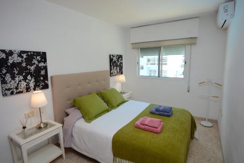 a bedroom with a bed with two towels on it at Vacacional Candelaria la Sardina in Candelaria