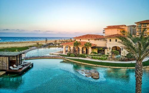 a pool at a resort near the ocean at Grand Solmar Pacific Dunes Resort, Golf & Spa in Cabo San Lucas
