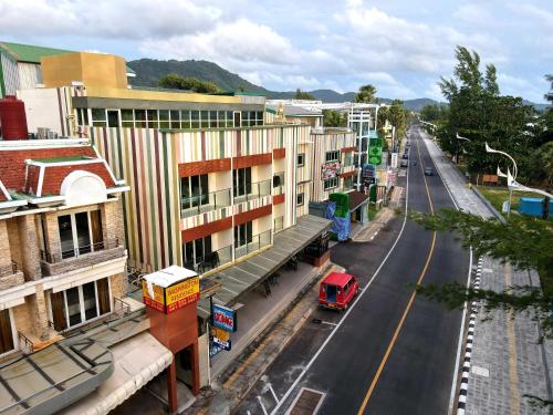 an aerial view of a city street with a red van at Anda Beachside Hotel in Karon Beach