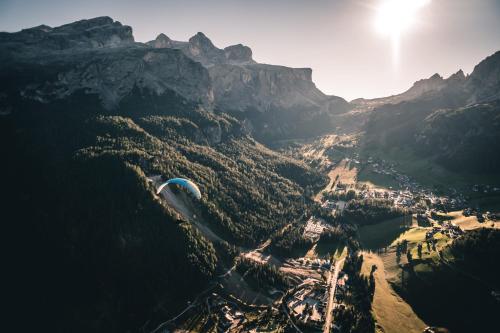 an aerial view of a valley in the mountains at Hotel Jägerhof in Colfosco
