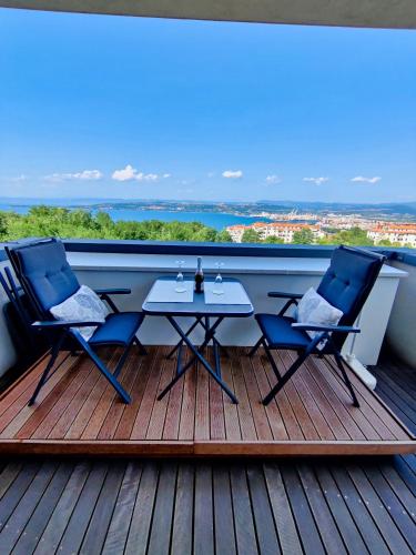 a patio with two chairs and a table on a deck at Lux -Luxury Sea and Mountains View Apartment-NEW in Koper