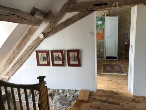 a room with three pictures on the wall at Côte du Jardin in Pouillé