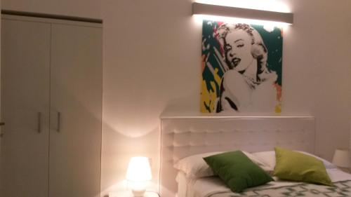 a bedroom with a bed and a painting on the wall at Divine Bed & Breakfast in Rome