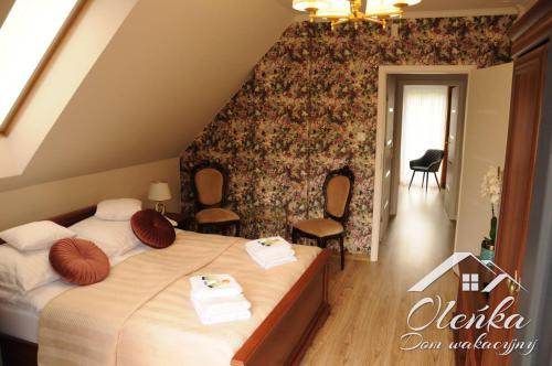 a bedroom with a bed with two towels on it at Dom Oleńka- Kaszuby, weekend, wakacje, sauna, jacuzzi, jezioro in Garcz