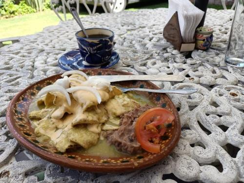 a plate of food with meat and vegetables on a table at Casa Loteria in San Miguel de Allende