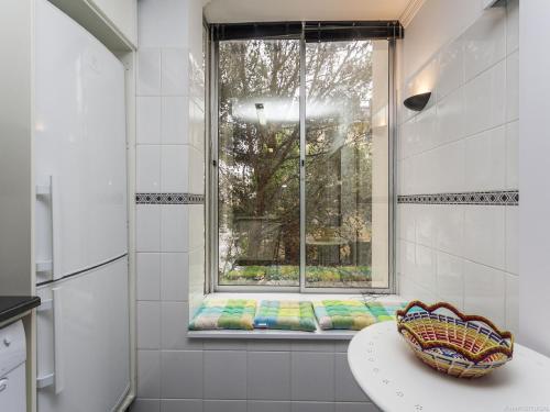 a bathroom with a window with a bench in front of it at Guia Acacias Apartment in Cascais