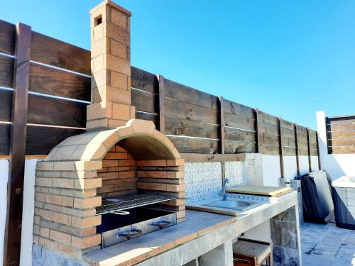 an outdoor brick pizza oven on a patio at Canary Wild House 2 in Carrizal