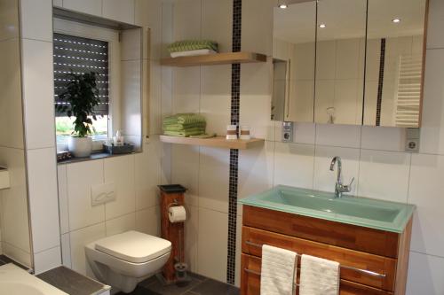 a bathroom with a sink and a toilet at Ferienwohnung Forellenhof in Handthal