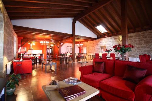a living room with a red couch and a table at Casa Rural Osante in Labastida