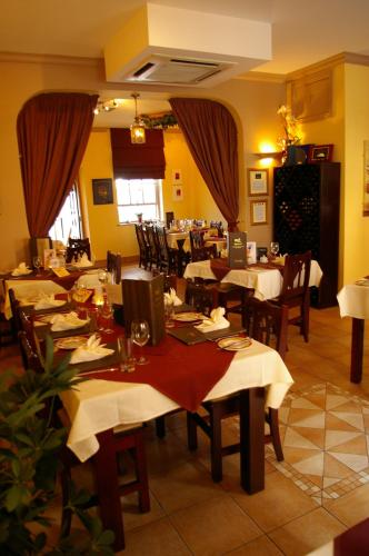 a dining room with tables and chairs in a restaurant at Befani's Mediterranean Restaurant & Townhouse in Clonmel