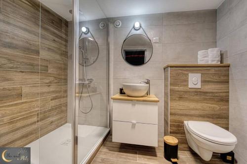 a bathroom with a shower and a toilet and a sink at La chambre noire au coeur de Metz (unenuitametz) in Metz