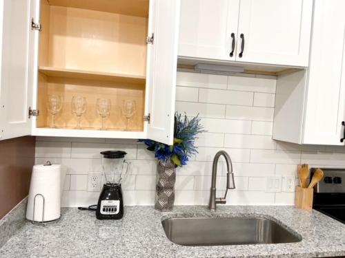 a kitchen counter with a sink and a mixer at Upscale Condo Full Kitchen Balcony Rooftop Pool in Jacksonville